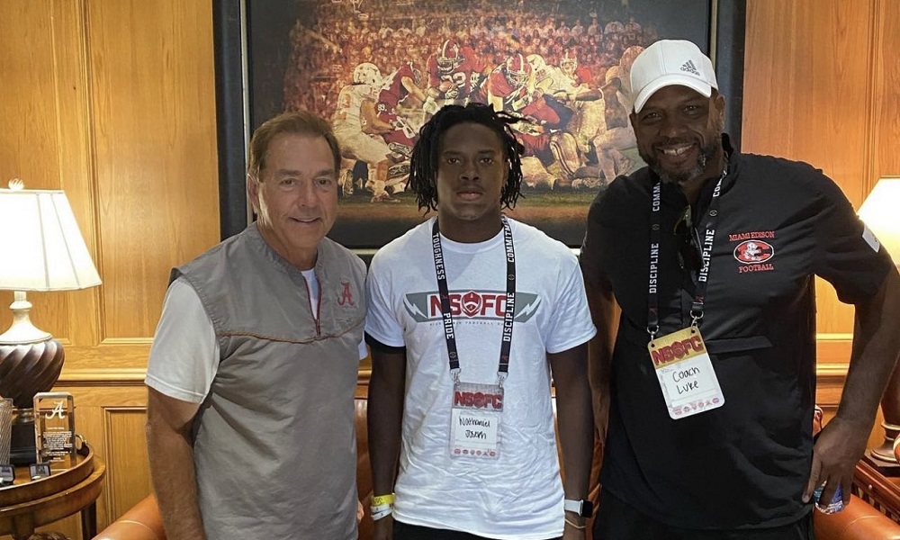 Nathaniel Joseph poses for picture with Nick Saban and Uncle Luke