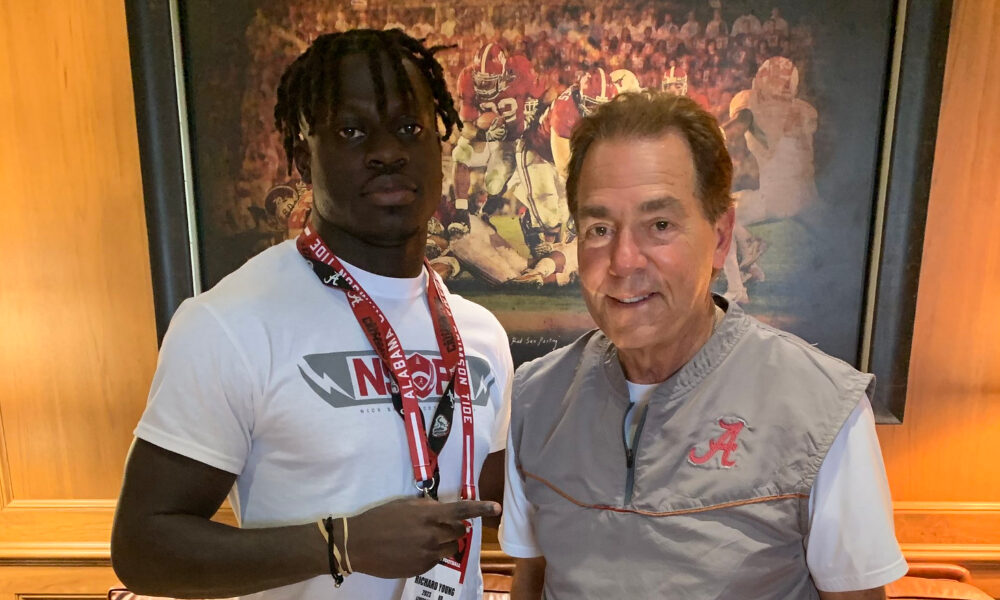 Richard Young takes picture alongside Nick Saban