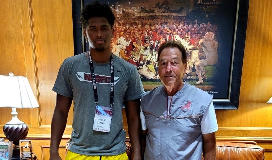 jayden wayne poses for picture with nick saban during visit to Alabama