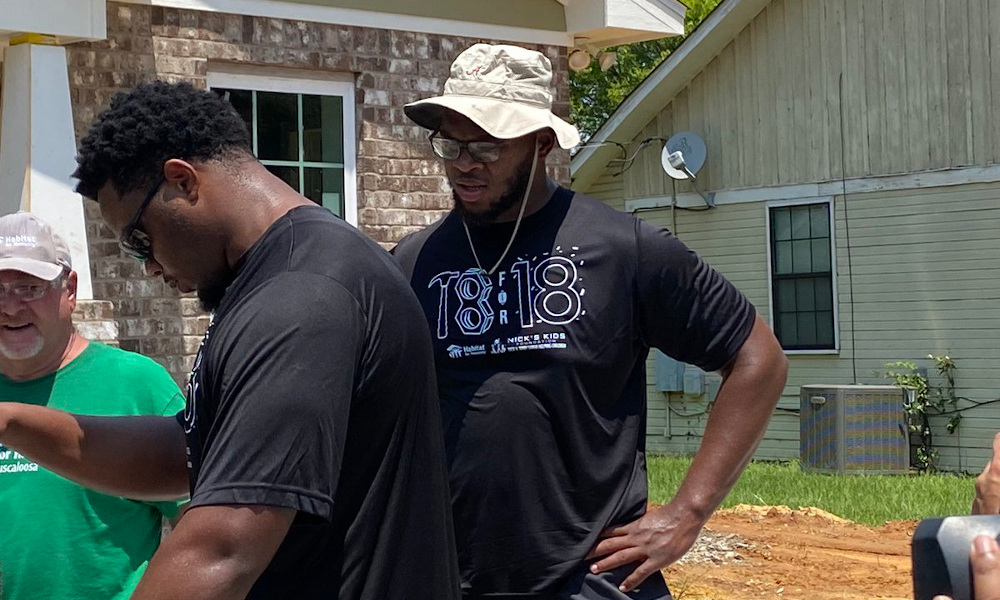 Evan Neal participating in Habitat for Humanity with Nick's Kids Foundation