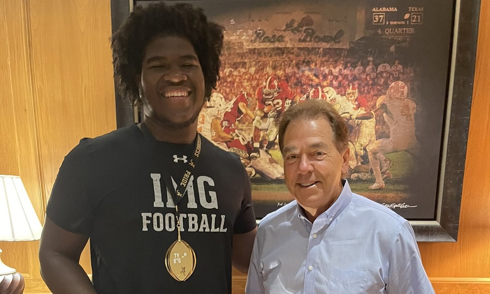 Nick Saban and Tyler Booker smile for picture