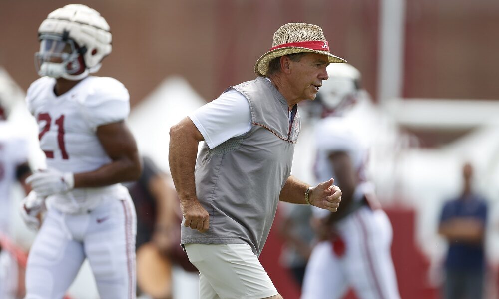 Nick Saban running during practice at fall camp for Alabama