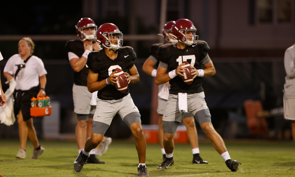 Bryce Young and Paul Tyson attempting passes in Alabama fall practice