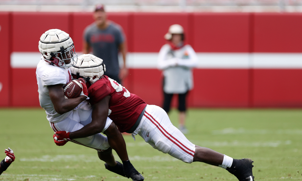 Jah-Marien Latham (No. 93) tackles Brian Robinson (No. 4) at Alabama's scrimmage last week