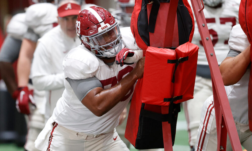 Alabama OL Chris Owens hits the sled at practice