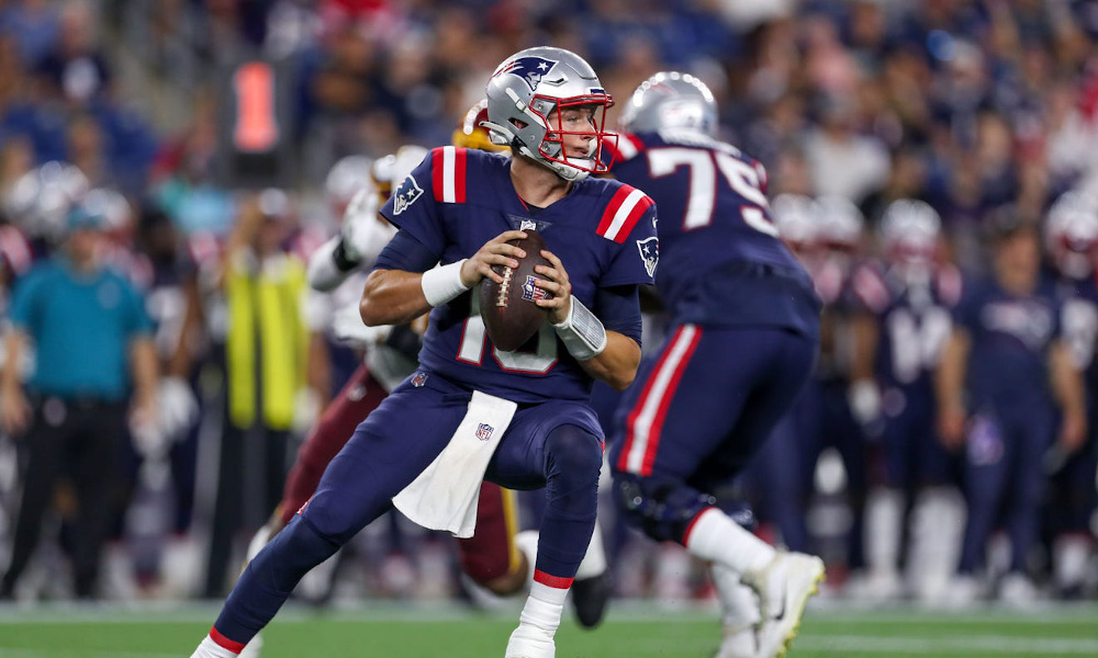 Mac Jones (No. 10) setting up to throw for Patriots in Thursday's NFL Preseason Game versus Washington