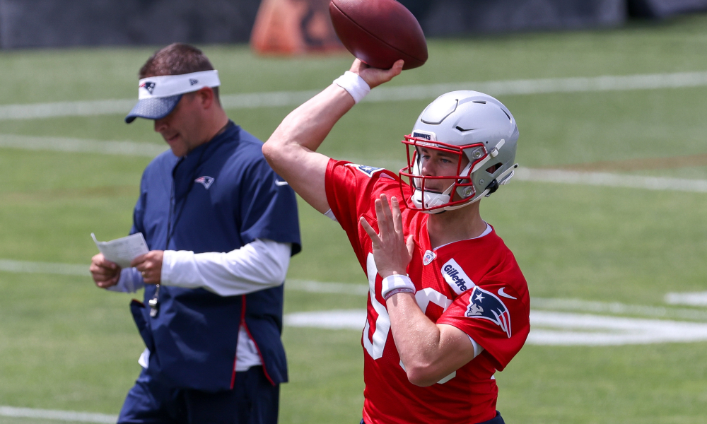 Mac Jones attempts a throw at Patriots OTAs with Josh McDaniels looking on