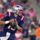 Mac Jones drops back to pass during NFL preseason for Patriots