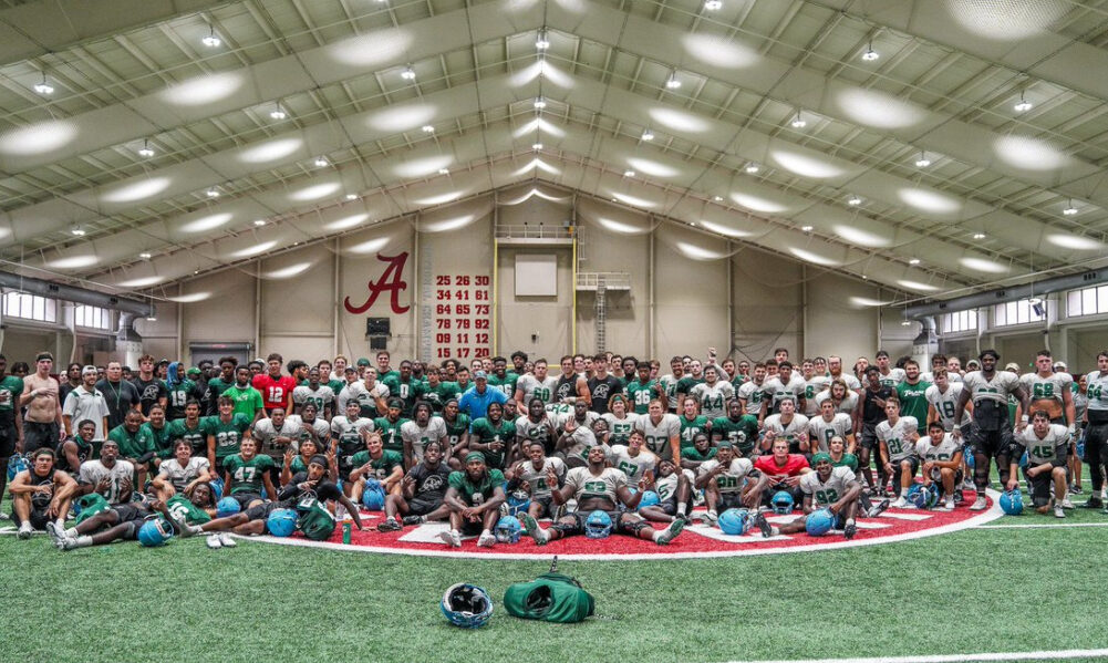 Tulane takes a team photo inside Alabama's practice facility