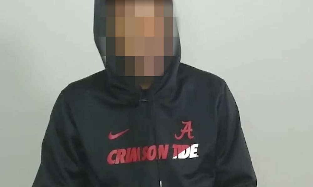 blurred face alabama fan with black Crimson Tide hoodie
