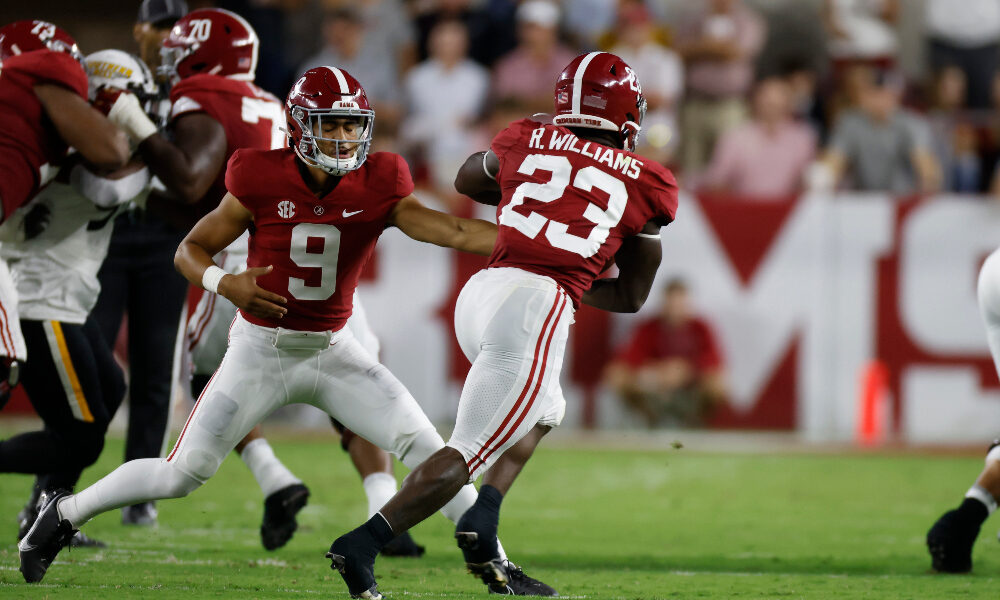 Bryce Young hands the ball off to Roydell Williams