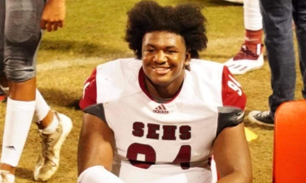 Jaquize Buycks sitting on the sideline during a game.