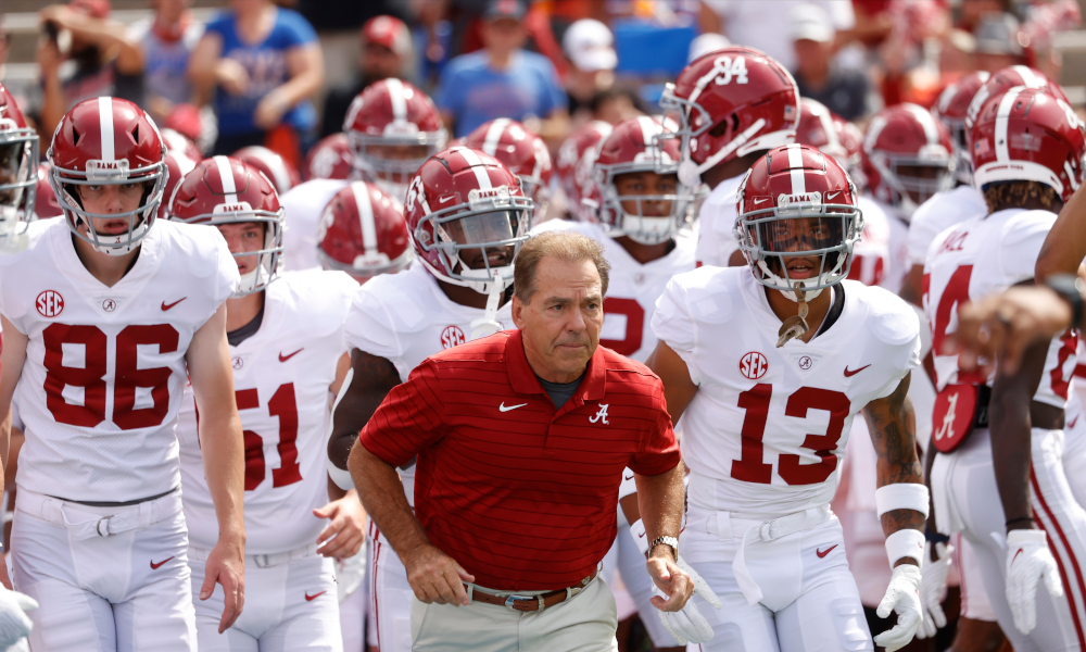Nick Saban leads Tide players on the field versus Florida