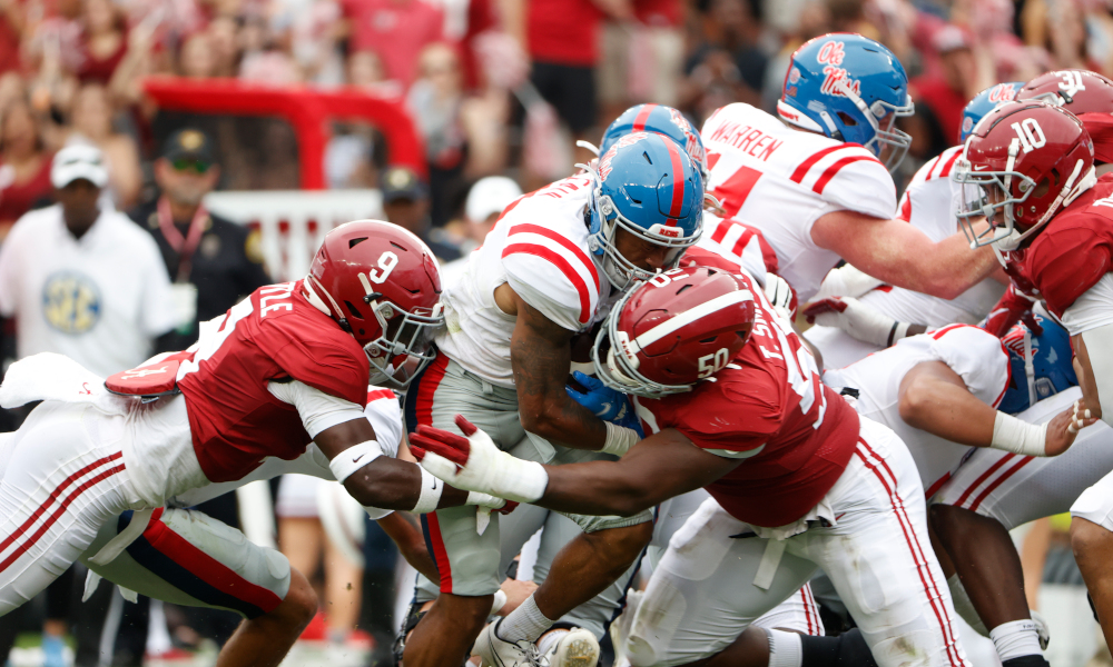 Tim Smith (#50) and Jordan Battle (#9) of Alabama make a fourth down stop versus Ole Miss