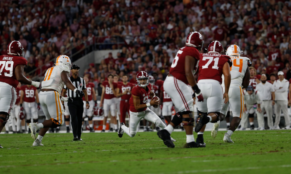 Bryce Young (#9) running with the ball for Alabama versus Tennessee