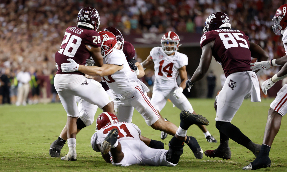 Henry To'oto'o (#10) and Will Anderson (#31) for Alabama tackling Texas A&M running back Isaiah Spiller