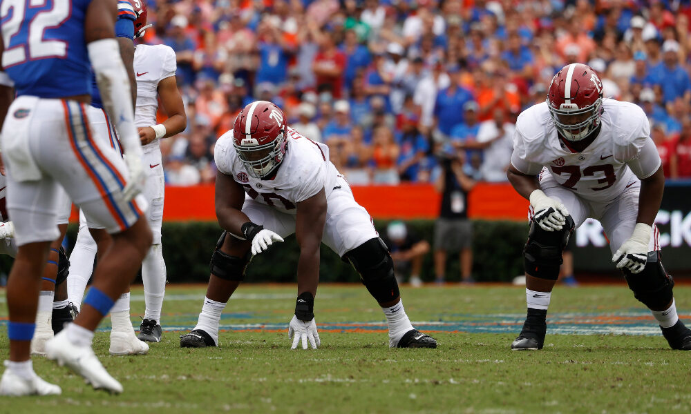 Javion Cohen lines up next to Evan Neal against Florida