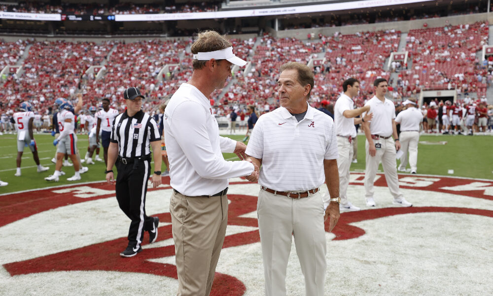 Lane Kiffin and Nick Saban talk at midfield before the game