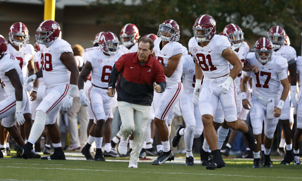 Nick Saban leads the team onto the field against Mississippi State