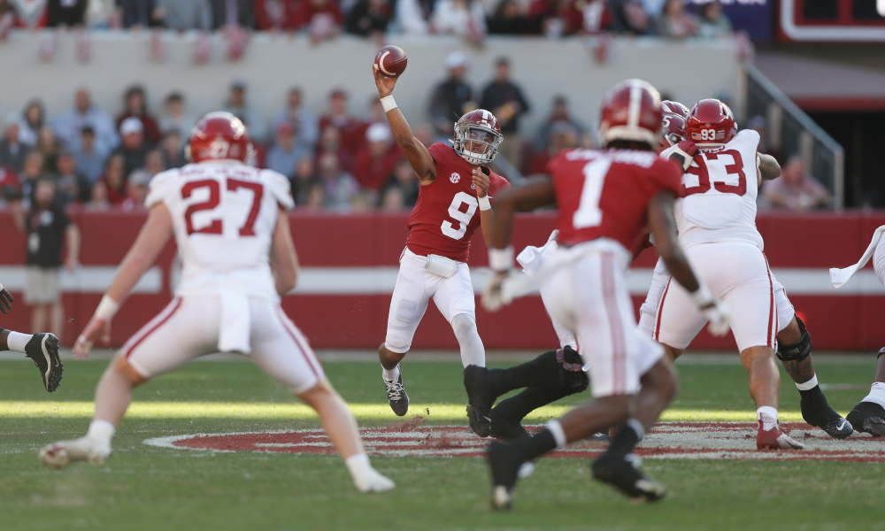 Bryce Young (#9) throws a pass for Alabama versus Arkansas