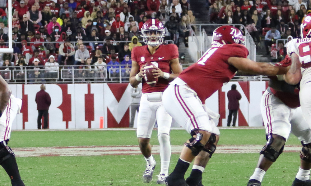 Bryce Young (#9) drops back to pass for Alabama versus Arkansas