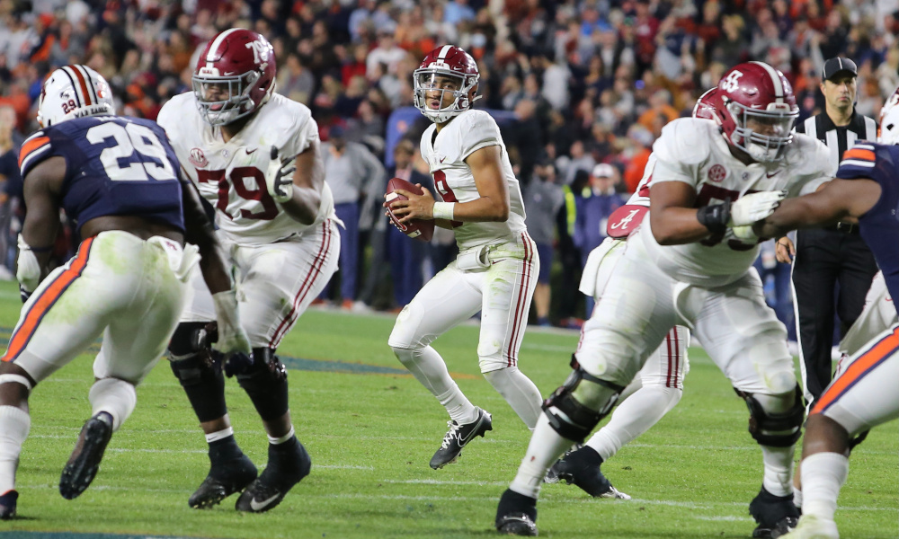 Bryce Young (#9) drops back to pass for Alabama in 2021 Iron Bowl