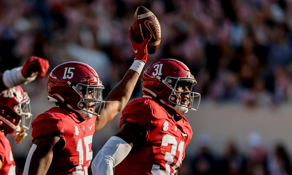 Dallas Turner (#15) and Will Anderson (#31) celebrate a fumble recovery for Alabama versus Arkansas