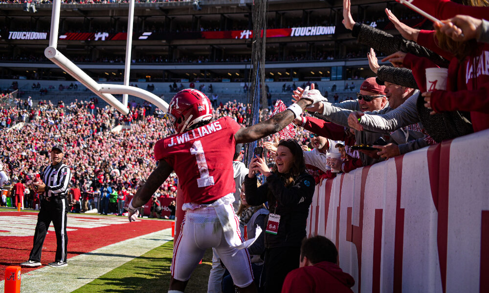 Jameson Williams high fives fans after scoring