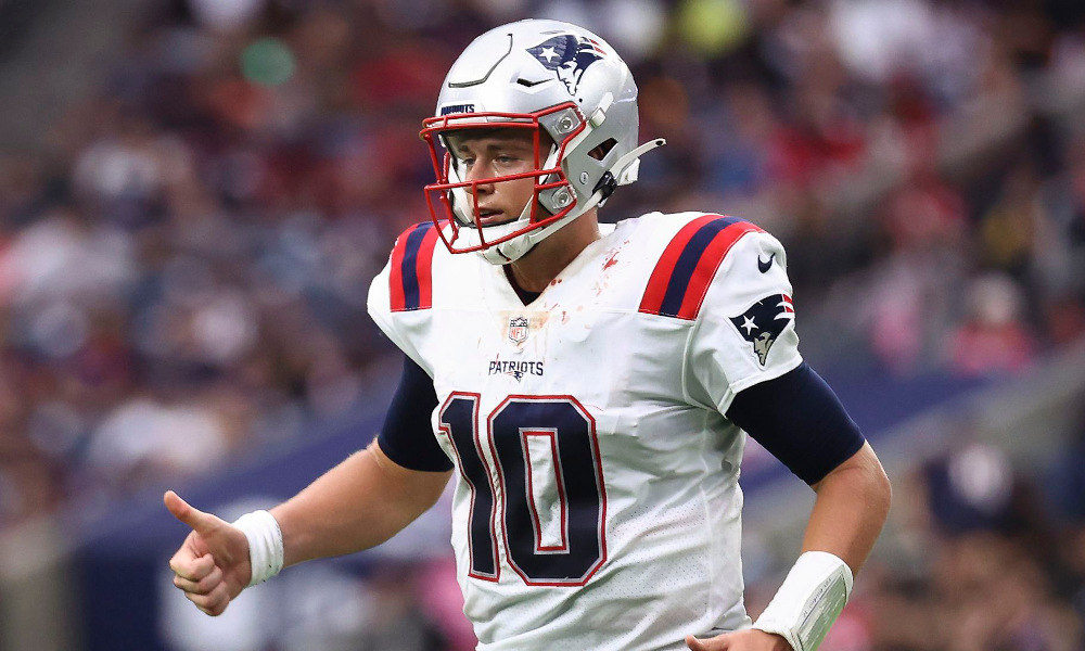 Mac Jones (#10) gives a thumbs up for Patriots in matchup versus Texans