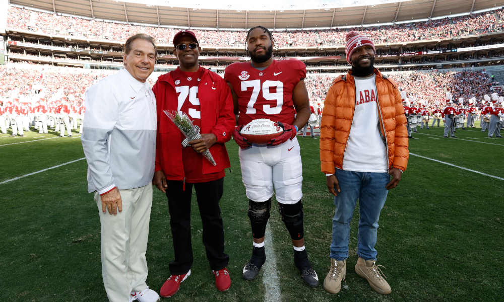 Chris Owens (#79) takes a photo with Nick Saban on senior day versus Arkansas