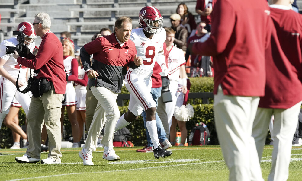 Nick Saban runs onto the field at Jordan-Hare Stadium