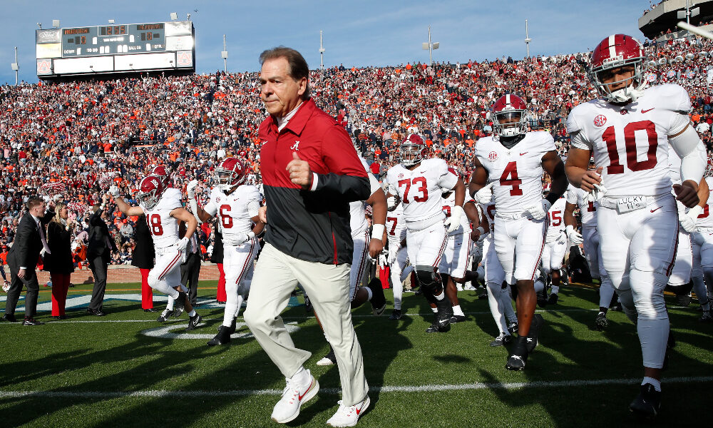 Nick Saban runs out of the tunnel at Jordan-Hare Stadium