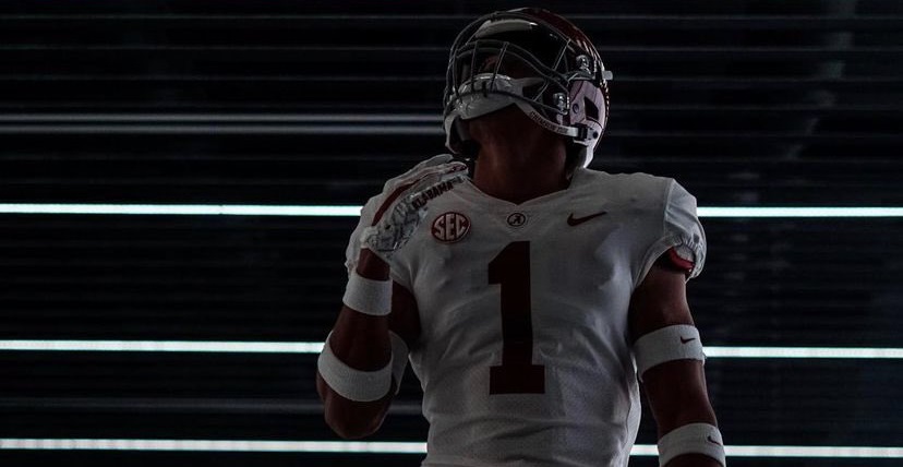dOMANI jACKSON throws ball in air during picture for alabama visit