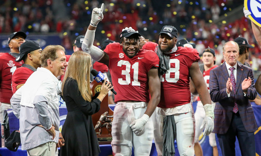 Will Anderson (#31) and Phidarian Mathis (#48) of Alabama celebrate SEC Championship victory over Georgia with the team