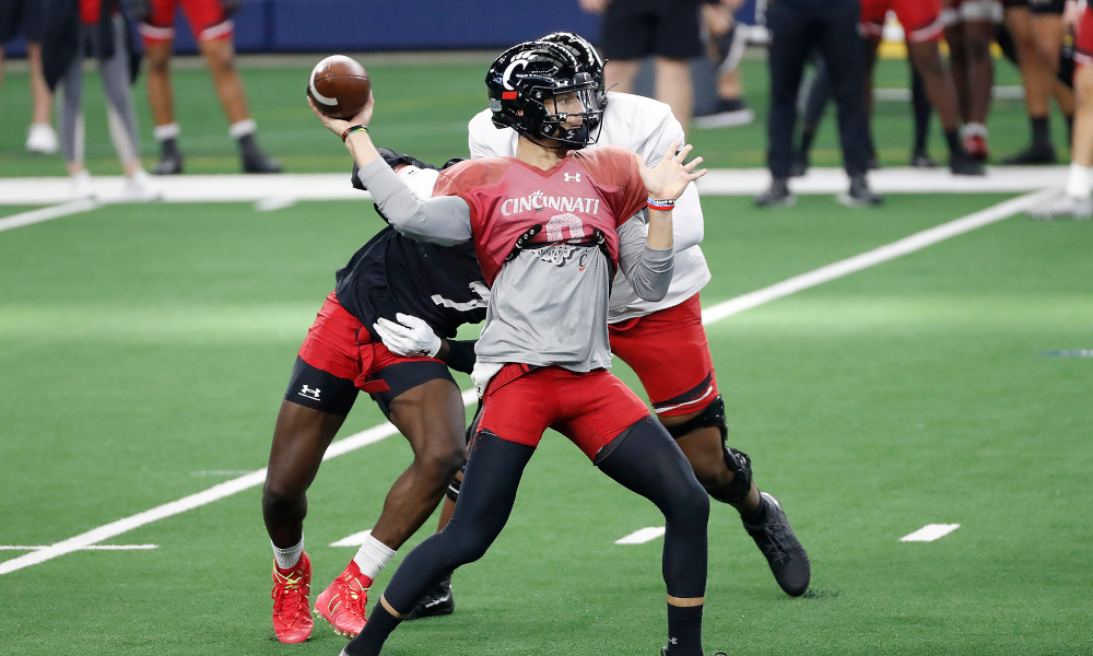 Desmond Ridder (#9) throws a pass for Cincinnati in CFP Semifinal prep for Alabama