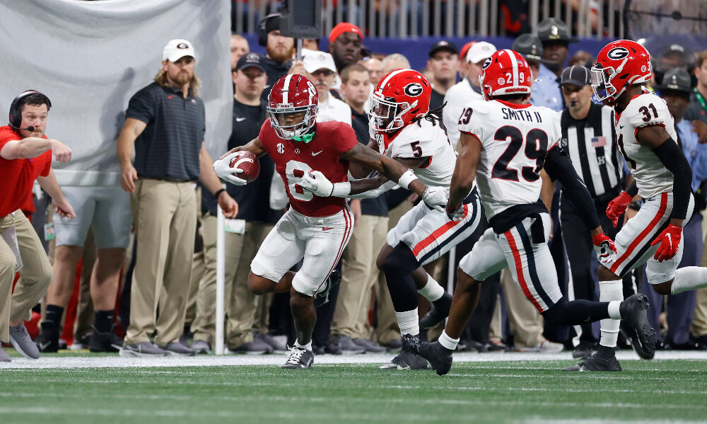 John Metchie breaks a tackle down the sidelines