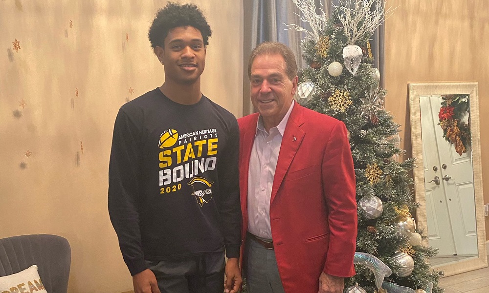 Nick Saban poses for a picture with Earl little Jr during visit