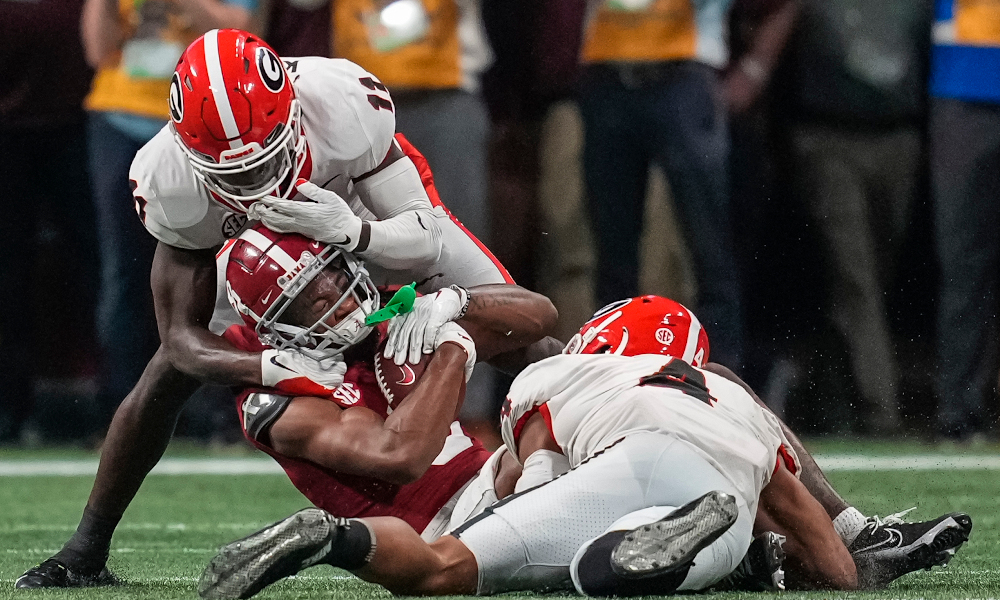John Metchie (#8) of Alabama tackled by Georgia defenders in 2021 SEC Championship Game