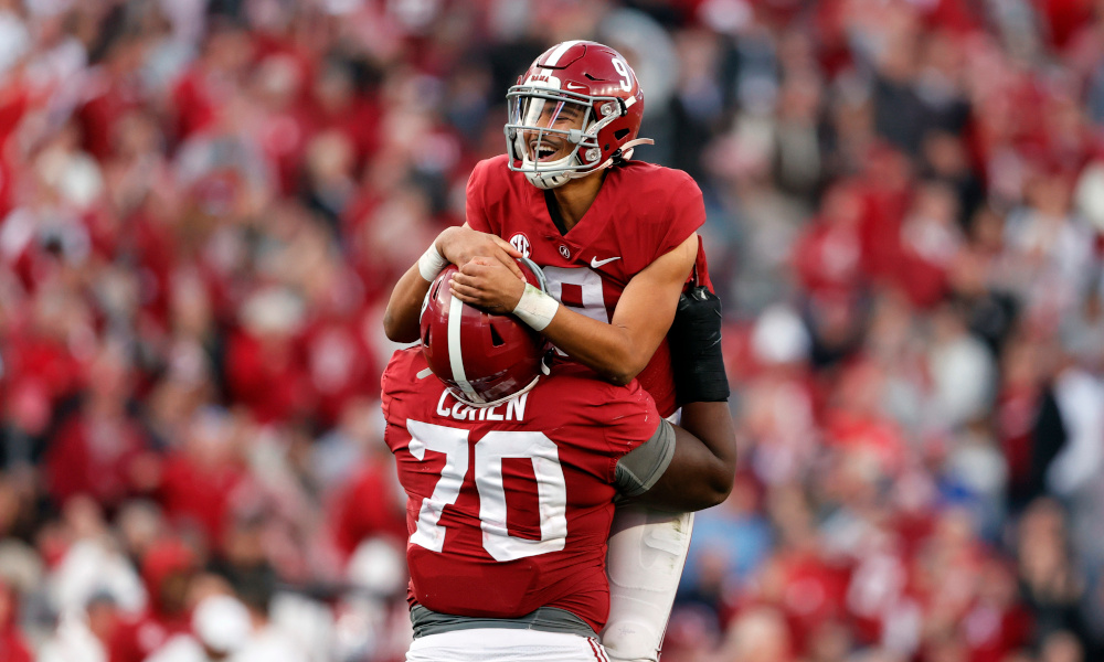 Bryce Young (#9) and Javion Cohen (#70) celebrate a touchdown for Alabama versus Arkansas in 2021 game