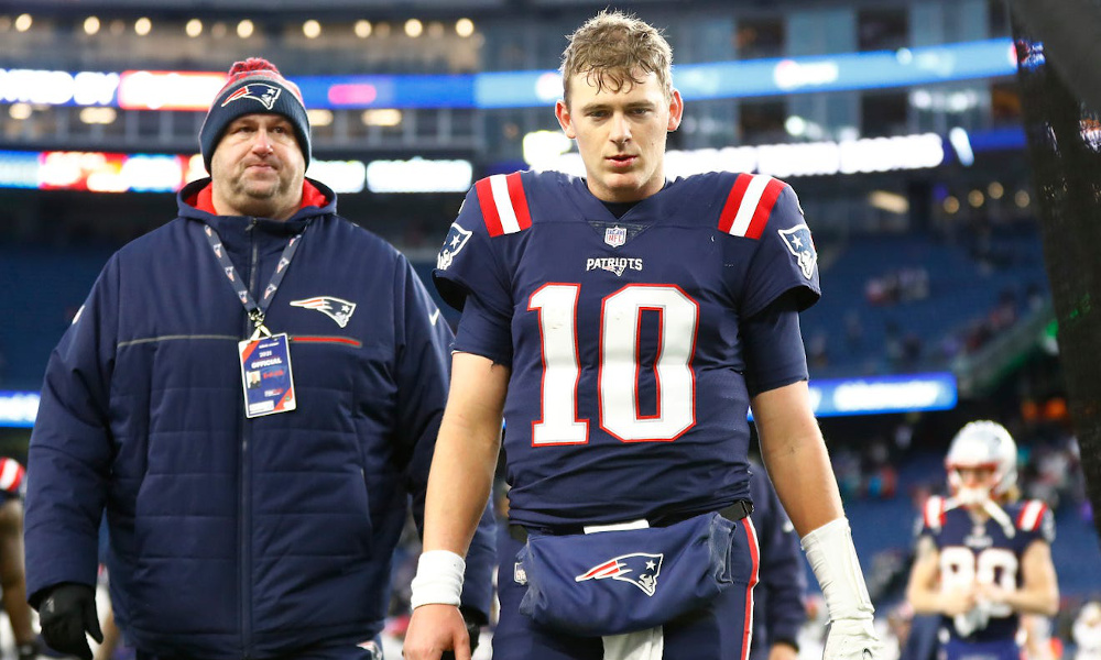 Mac Jones (#10) walks off the field for Patriots after 2021 regular season loss to Bills