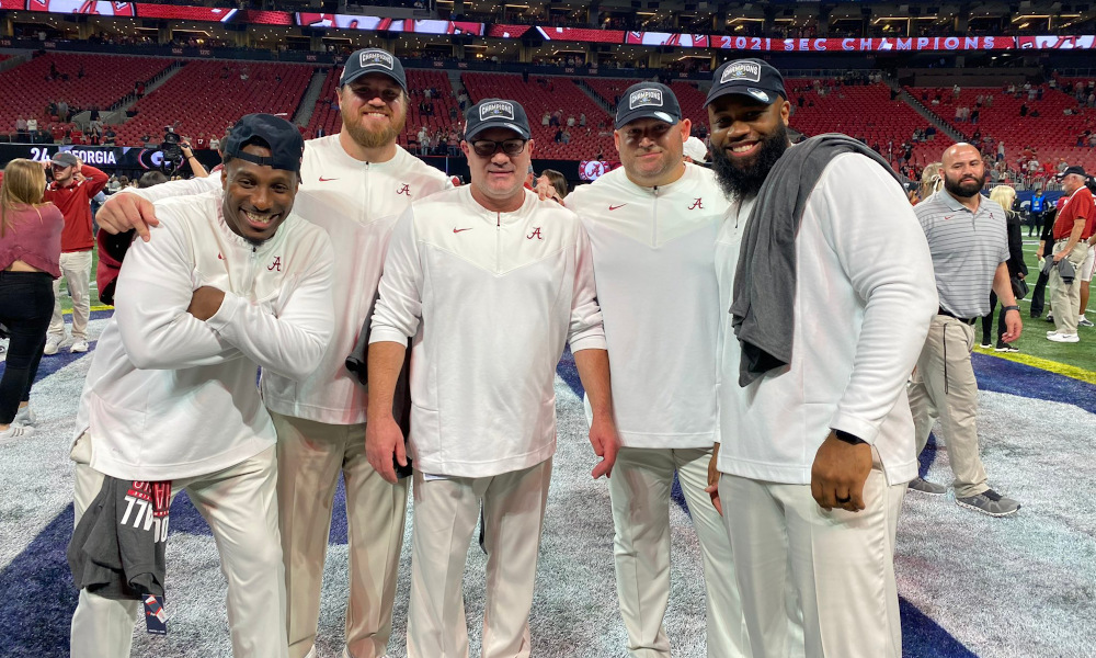 Alabama assistant strength coach, Paul Constantine, standing to the right of David Ballou in celebrating 2021 SEC Championship
