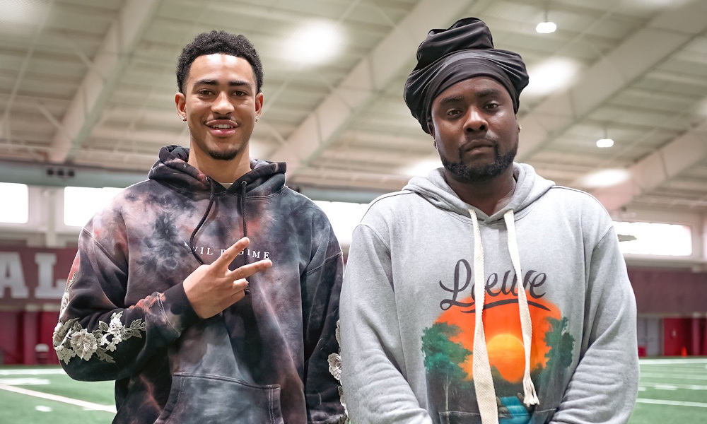 Alabama QB Bryce Young posing with Rapper Wale inside Crimson Tide's indoor practice facility