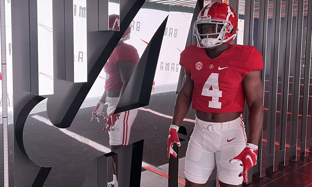 Kam davis in Alabama uniform during visit