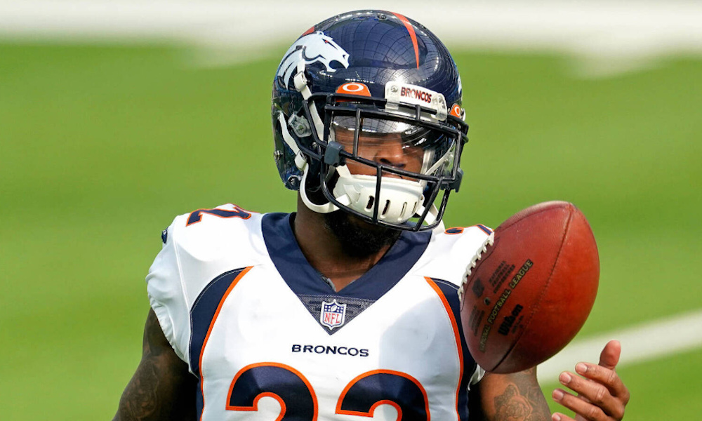 Broncos safety Kareem Jackson (#22) tosses a football up in pregame for 2020 matchup versus Los Angeles Chargers