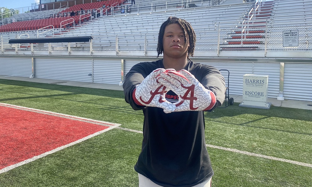 Peter Woods shows alabama gloves at Thompson practie