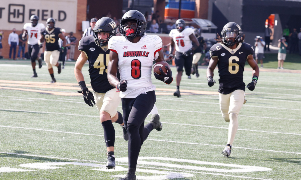 Tyler Harrell (#8) runs by Wake Forest's defense in 2021 for a Louisville touchdown