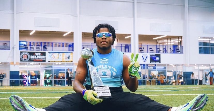 semaj bridgeman poses with 7v7 trophy