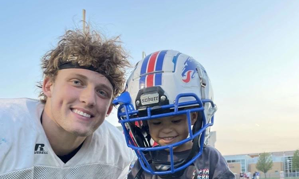 Miles Kitselman takes a photo with a fan after a game at Hutchinson Community College