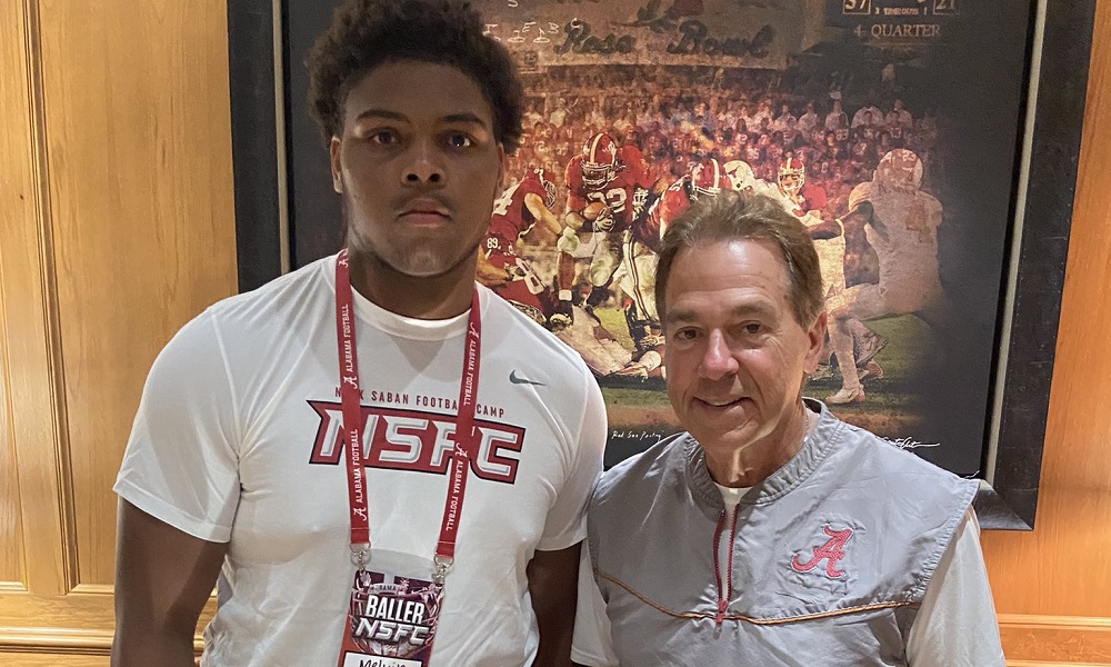 Melvin Hills and nick saban after alabama football camp