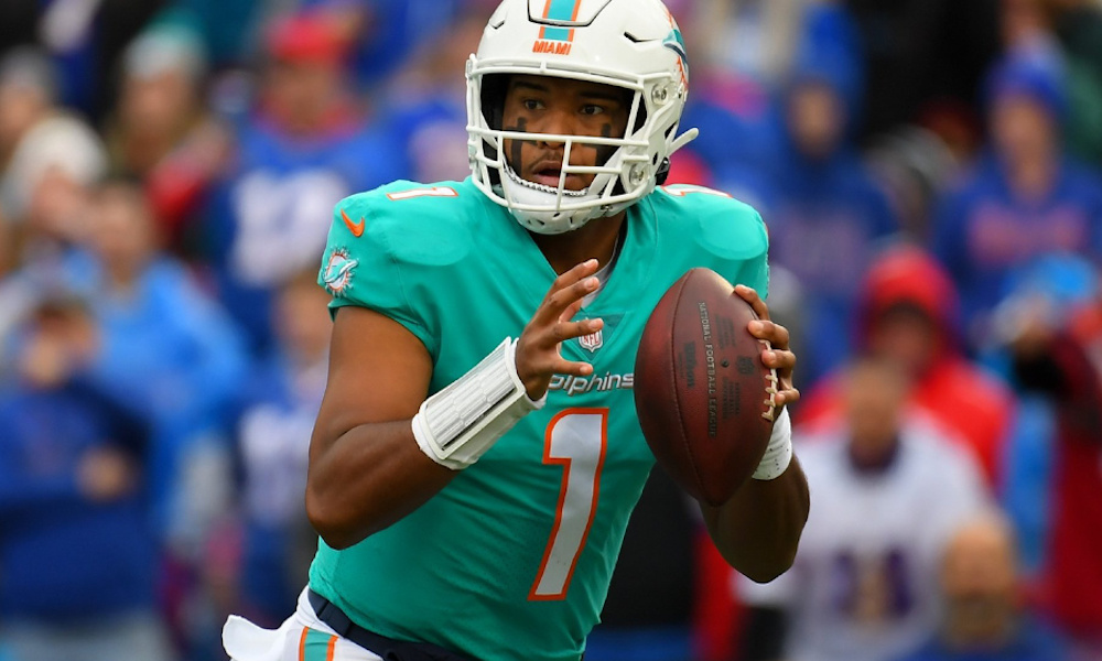 Tua Tagovailoa (#1) drops back to pass for Dolphins in 2021 game against Bills